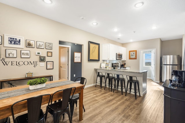 3112 S Vinyards Terrace Parkway Unit 4, Branson, MO 65616 - dining space featuring baseboards, light wood-style floors, and recessed lighting