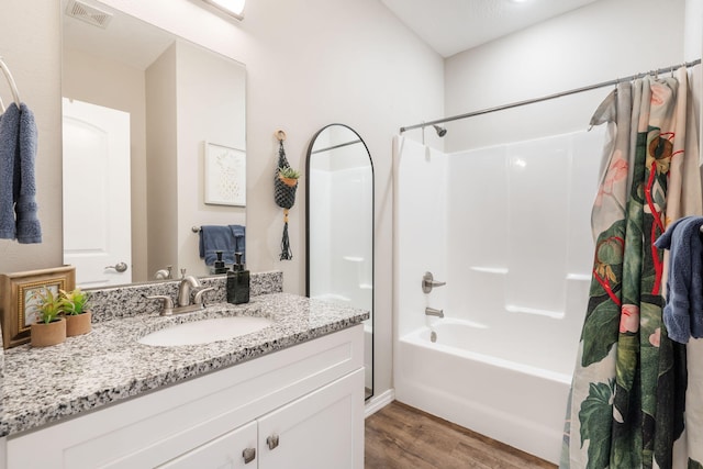 3112 S Vinyards Terrace Parkway Unit 4, Branson, MO 65616 - bathroom featuring wood finished floors, shower / bath combo with shower curtain, and vanity
