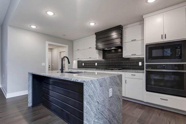 kitchen with black appliances, a sink, baseboards, dark wood-style floors, and custom exhaust hood