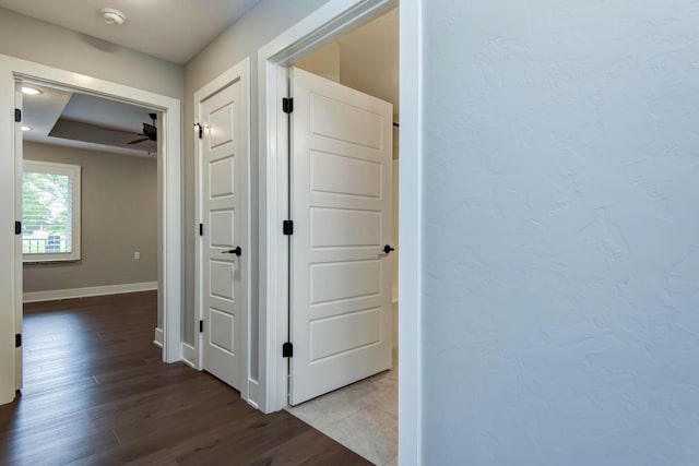 hall with wood finished floors and baseboards