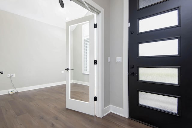 foyer entrance with wood finished floors and baseboards