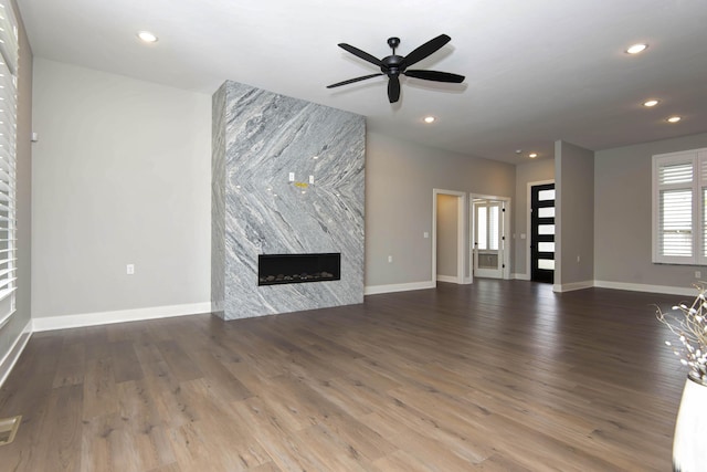 unfurnished living room featuring a fireplace, ceiling fan, wood finished floors, recessed lighting, and baseboards