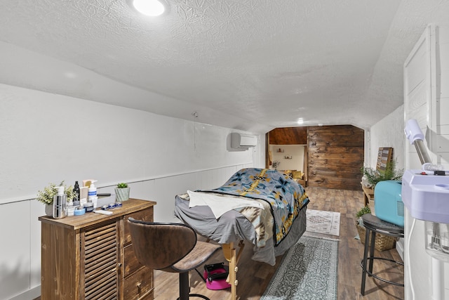 311 S Center St, Fordland, MO 65652 - bedroom featuring a textured ceiling, vaulted ceiling, a wall mounted air conditioner, wood finished floors, and wood walls