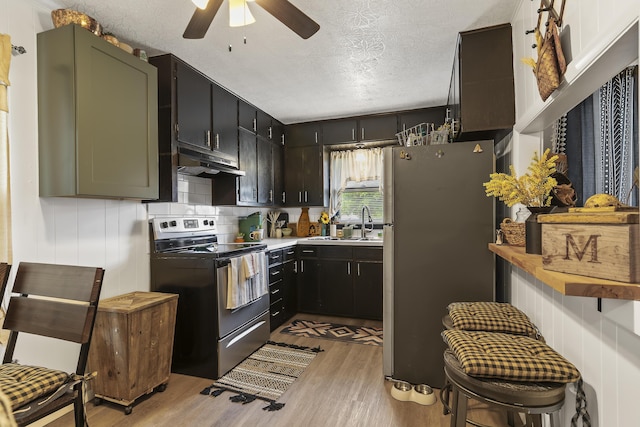311 S Center St, Fordland, MO 65652 - kitchen featuring stainless steel appliances, under cabinet range hood, ceiling fan, light wood-style floors, and a textured ceiling