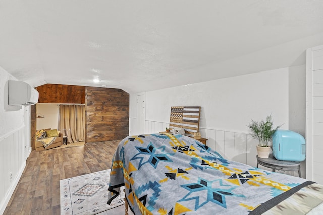 311 S Center St, Fordland, MO 65652 - bedroom featuring a wall mounted air conditioner, wood-type flooring, and vaulted ceiling