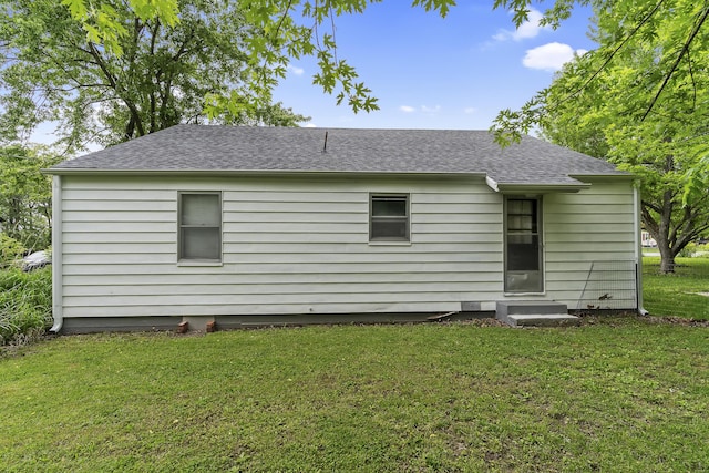 311 S Center St, Fordland, MO 65652 - rear view of house with entry steps, a lawn, and roof with shingles