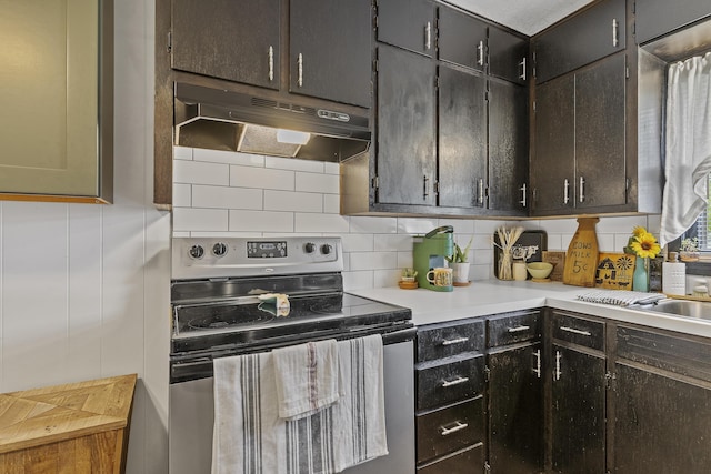 311 S Center St, Fordland, MO 65652 - kitchen with under cabinet range hood, stainless steel range with electric stovetop, backsplash, and light countertops