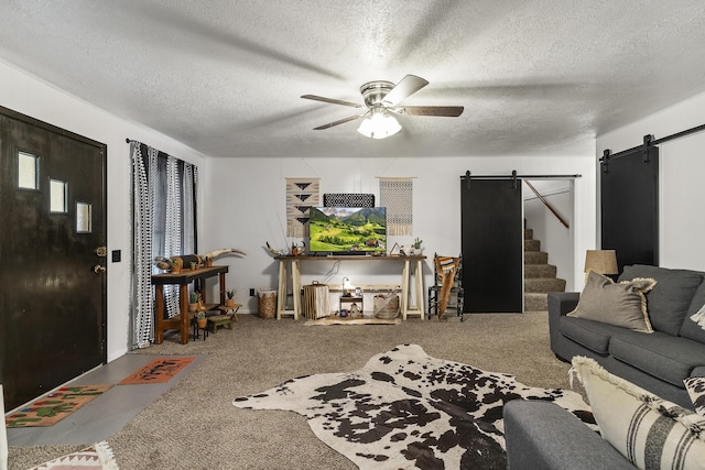 311 S Center St, Fordland, MO 65652 - living area with a barn door, a ceiling fan, a textured ceiling, and carpet flooring
