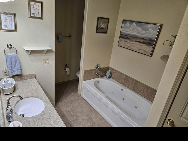 71 Birdie Ln Unit 3, Branson West, MO 65737 - full bathroom with tile patterned floors, toilet, a tub with jets, and vanity