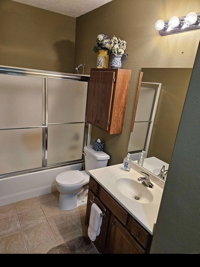 71 Birdie Ln Unit 3, Branson West, MO 65737 - bathroom with toilet, tile patterned flooring, vanity, enclosed tub / shower combo, and a textured wall