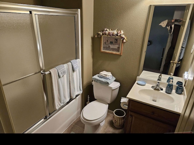71 Birdie Ln Unit 3, Branson West, MO 65737 - full bathroom with vanity, toilet, combined bath / shower with glass door, baseboards, and tile patterned floors