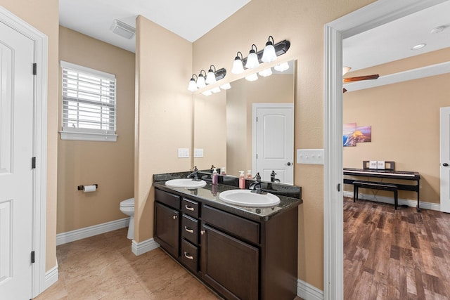 122 Thunder Ridge Ct, Branson, MO 65616 - bathroom with toilet, double vanity, and baseboards