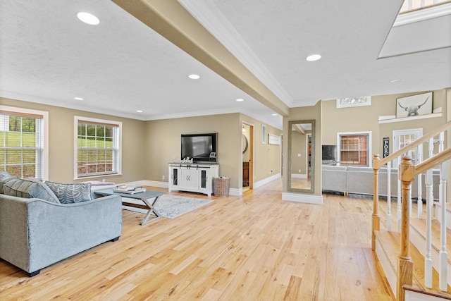 living room with wood finished floors, recessed lighting, baseboards, and crown molding