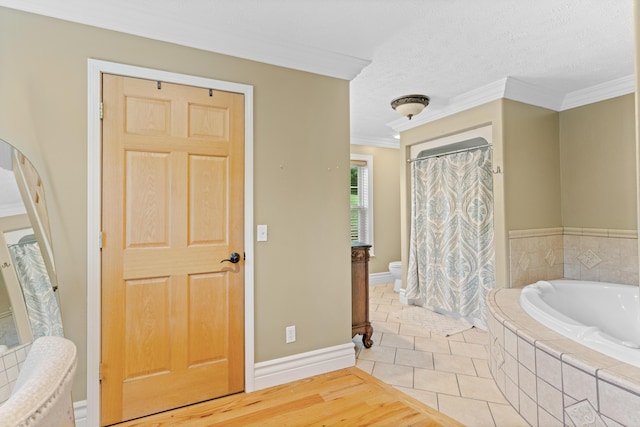 full bathroom with crown molding, a garden tub, toilet, baseboards, and tile patterned floors