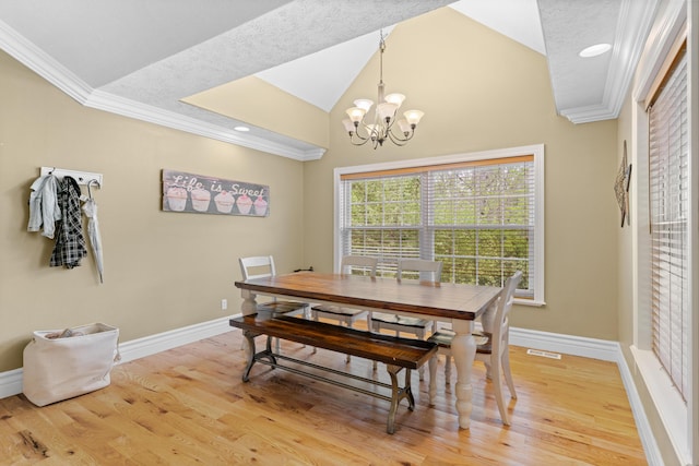 dining room with crown molding, a chandelier, light wood-style flooring, baseboards, and lofted ceiling