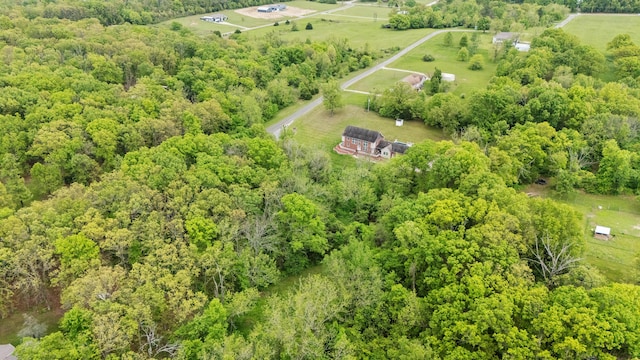 aerial view of property's location featuring a forest and rural landscape