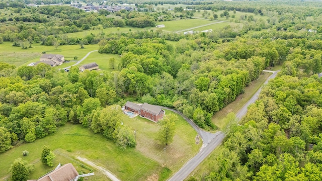 aerial view of sparsely populated area featuring a heavily wooded area