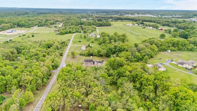 aerial overview of property's location with rural landscape and a heavily wooded area