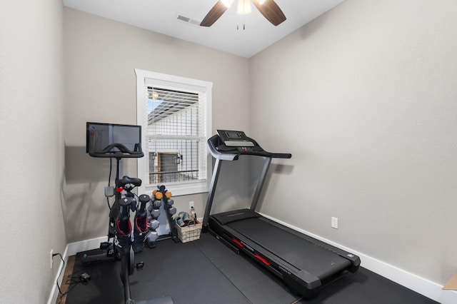 exercise area featuring ceiling fan and baseboards