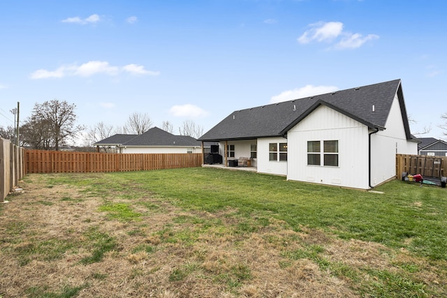 rear view of property with roof with shingles and a patio