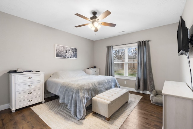 bedroom featuring dark wood finished floors, baseboards, and ceiling fan