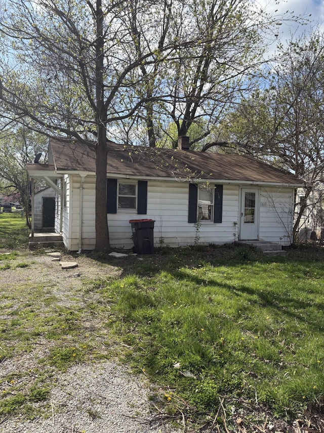 back of house featuring a yard