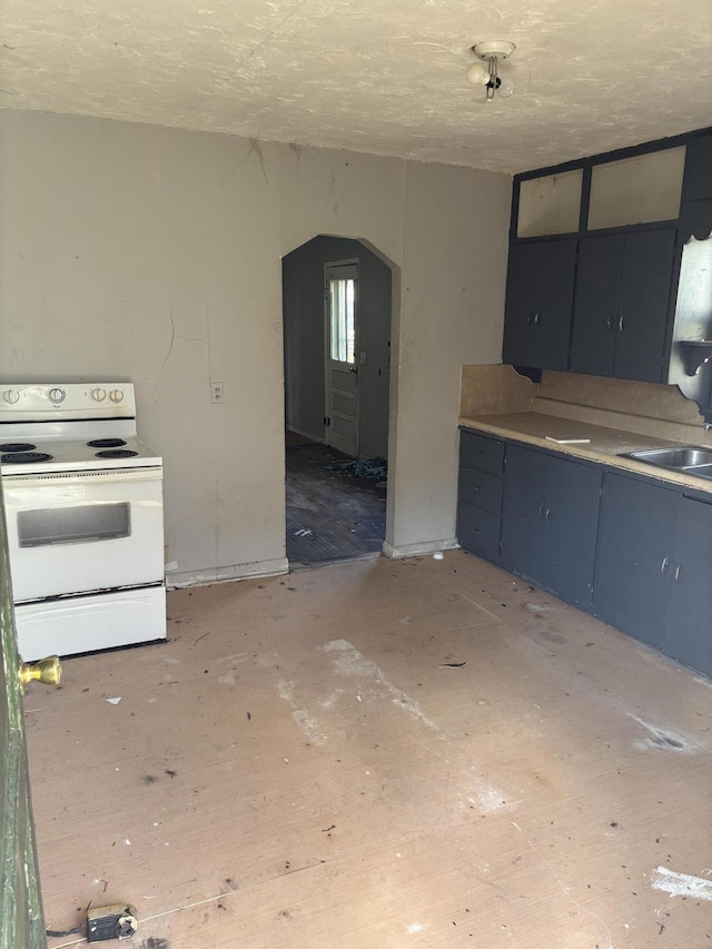 kitchen with electric range, arched walkways, a sink, and blue cabinets