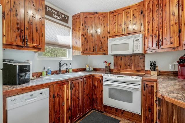 167 Motel Ln, Cape Fair, MO 65624 - kitchen featuring white appliances, a sink, and brown cabinetry