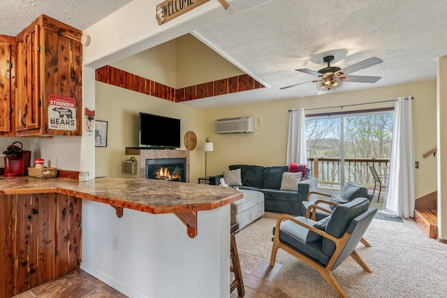 167 Motel Ln, Cape Fair, MO 65624 - living area featuring a textured ceiling, ceiling fan, a tiled fireplace, and a wall unit AC