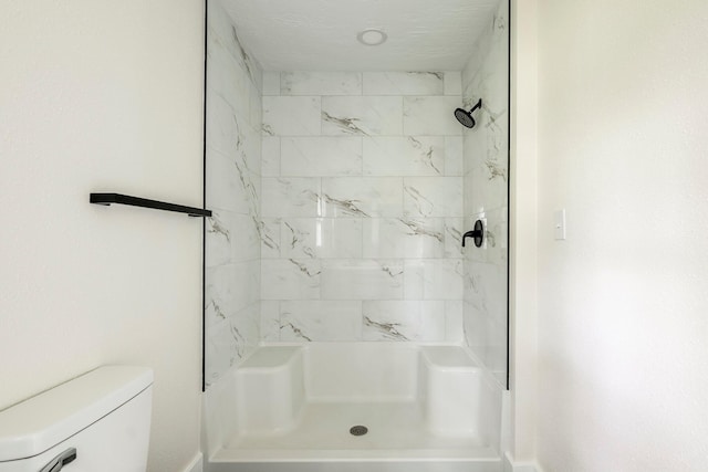 full bathroom with a stall shower and toilet