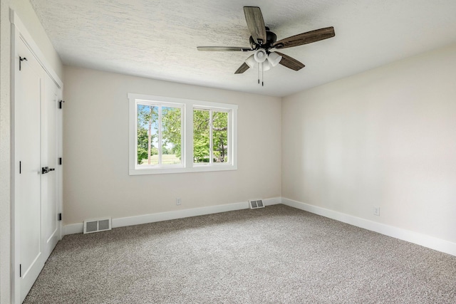 unfurnished bedroom featuring carpet flooring, baseboards, a ceiling fan, and a closet