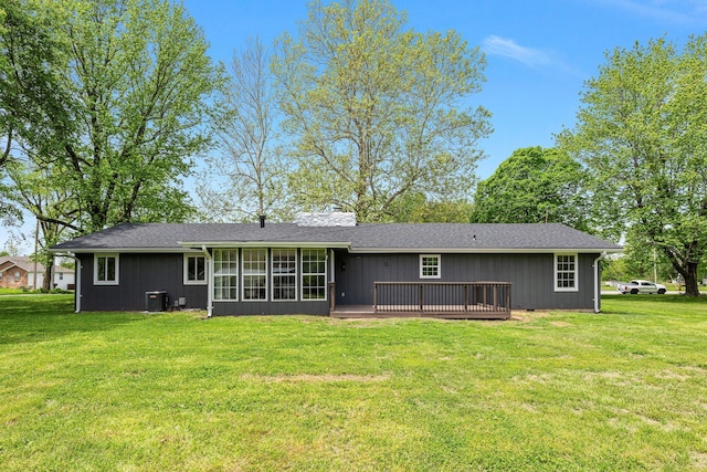 back of house with central AC, a yard, a deck, and a sunroom