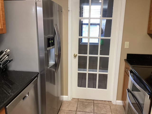 186 Bunker Ridge Dr Unit 2, Branson, MO 65616 - kitchen featuring appliances with stainless steel finishes, light tile patterned floors, and baseboards