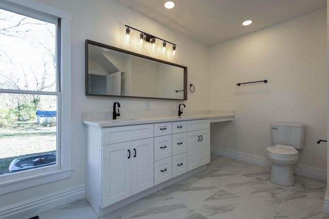 308 S 6th Ave, Ozark, MO 65721 - bathroom with baseboards, marble look tile flooring, toilet, double vanity, and recessed lighting