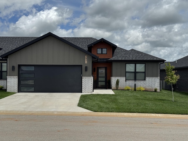 5955 S Farm Rd 163 205A, Springfield, MO 65810 - view of front of home with roof with shingles, brick siding, a garage, and driveway