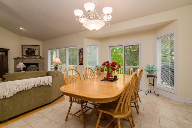 62 Turtledove Ln, Lampe, MO 65681 - dining space featuring light tile patterned floors, vaulted ceiling, a chandelier, a fireplace, and baseboards