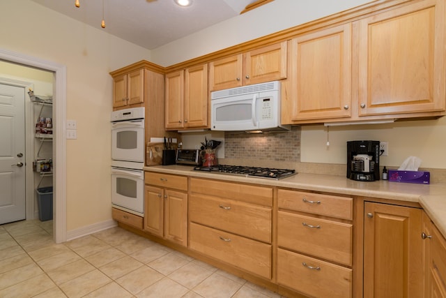 62 Turtledove Ln, Lampe, MO 65681 - kitchen featuring white appliances, light tile patterned floors, light countertops, backsplash, and light brown cabinetry