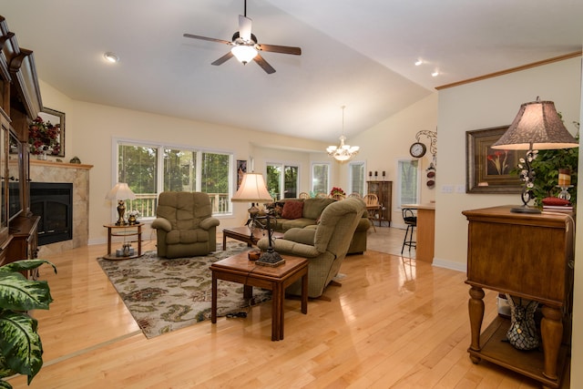 62 Turtledove Ln, Lampe, MO 65681 - living area with a chandelier, vaulted ceiling, a tiled fireplace, light wood-style floors, and ceiling fan