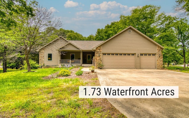 62 Turtledove Ln, Lampe, MO 65681 - view of front facade with covered porch, stone siding, concrete driveway, and a garage