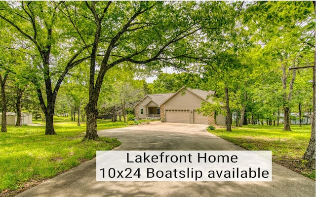 62 Turtledove Ln, Lampe, MO 65681 - view of front of home featuring asphalt driveway, an attached garage, a front yard, and brick siding
