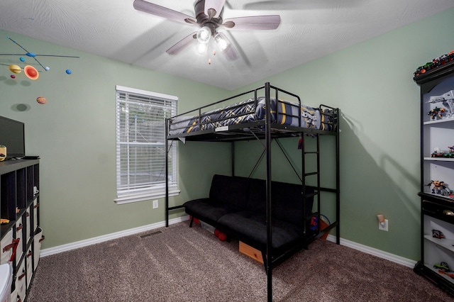 carpeted bedroom with baseboards and a ceiling fan