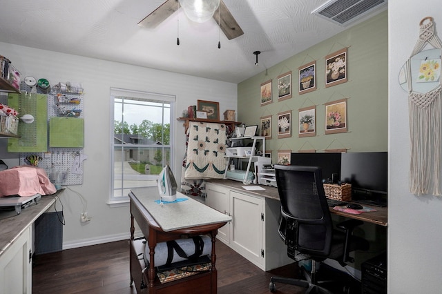home office with dark wood-style flooring, ceiling fan, and baseboards