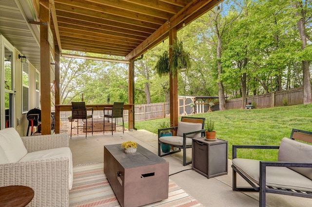 view of patio / terrace featuring an outdoor living space and view of wooded area