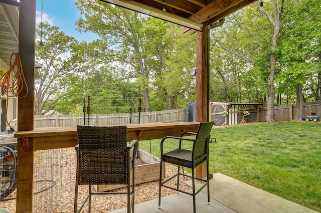 view of patio with an outdoor structure and a shed