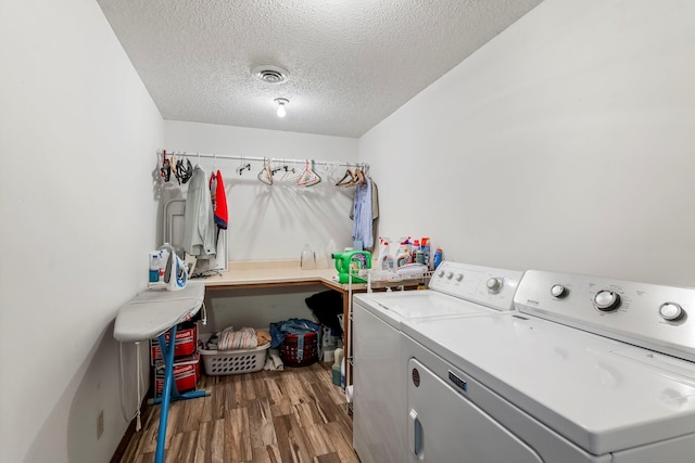 4949 S 196th Rd, Halfway, MO 65663 - washroom featuring separate washer and dryer, wood finished floors, and a textured ceiling