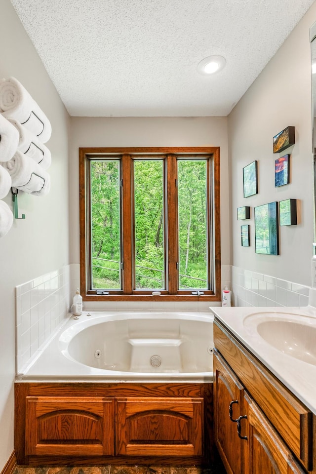 4949 S 196th Rd, Halfway, MO 65663 - bathroom featuring a textured ceiling, healthy amount of natural light, a jetted tub, and vanity