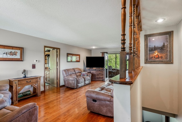 4949 S 196th Rd, Halfway, MO 65663 - living room featuring a textured ceiling and wood finished floors