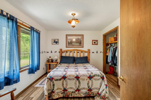 4949 S 196th Rd, Halfway, MO 65663 - bedroom with a textured ceiling, multiple windows, and wood finished floors