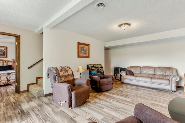 4949 S 196th Rd, Halfway, MO 65663 - living area featuring light wood-style floors, a textured ceiling, stairway, and baseboards