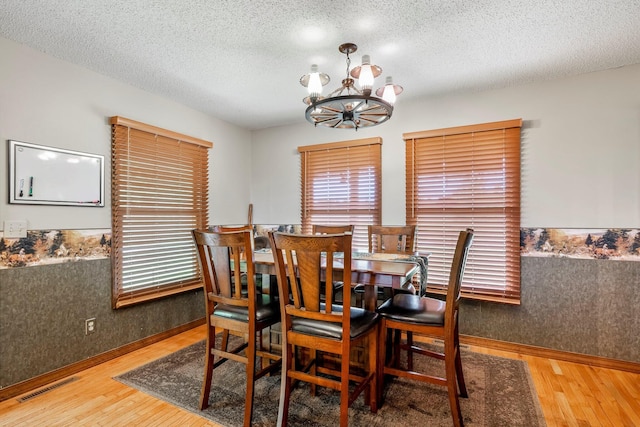 4949 S 196th Rd, Halfway, MO 65663 - dining room with wood finished floors, a chandelier, plenty of natural light, and a textured ceiling